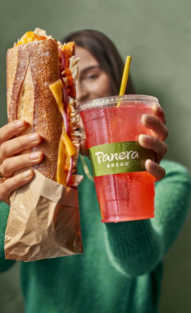 Panera Bread baguette with drink held by a shopper